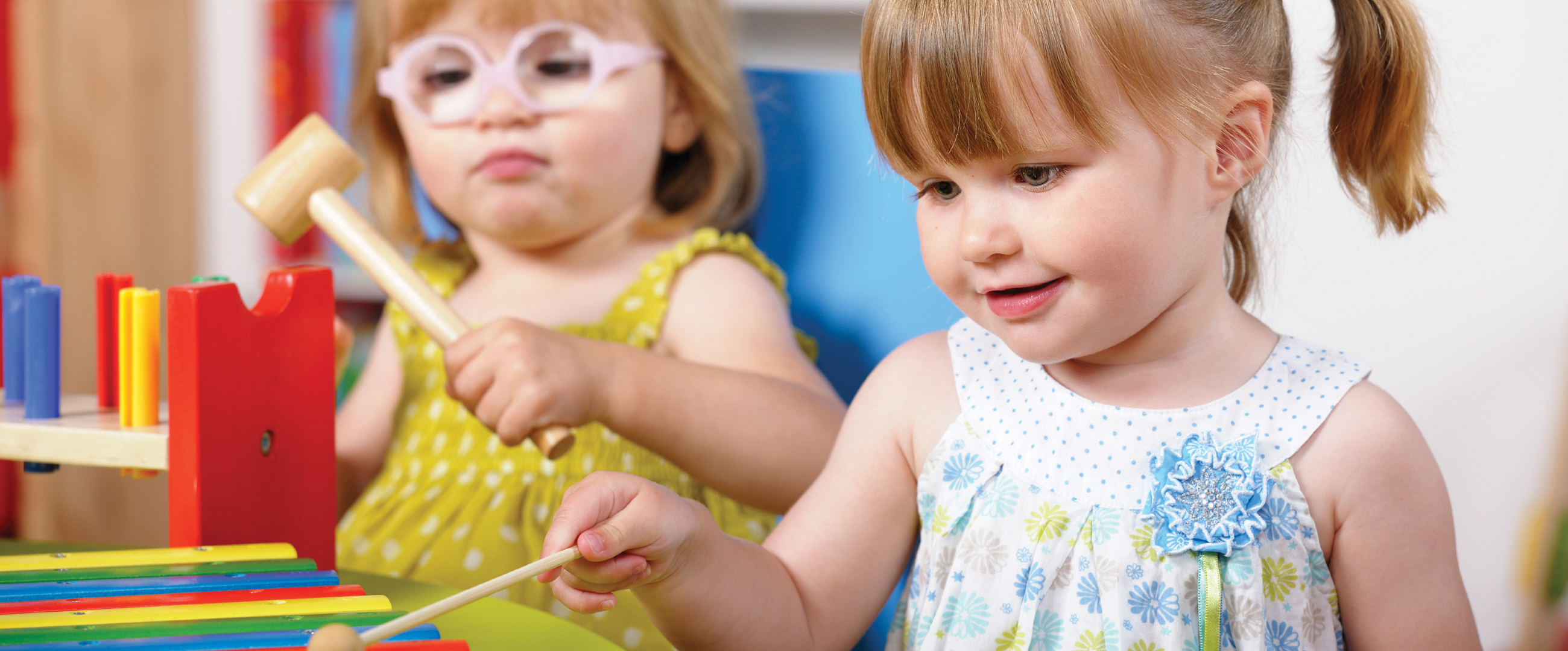 two young girls playing in classroom